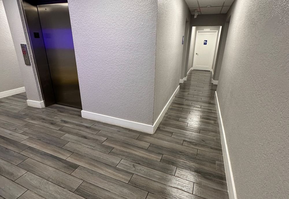 Clean commercial hallway and elevator lobby, ready for the workday