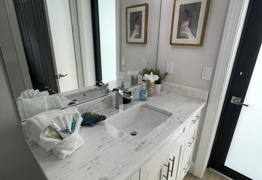 Bathroom vanity tidied and stocked with fresh towels during a maid service visit